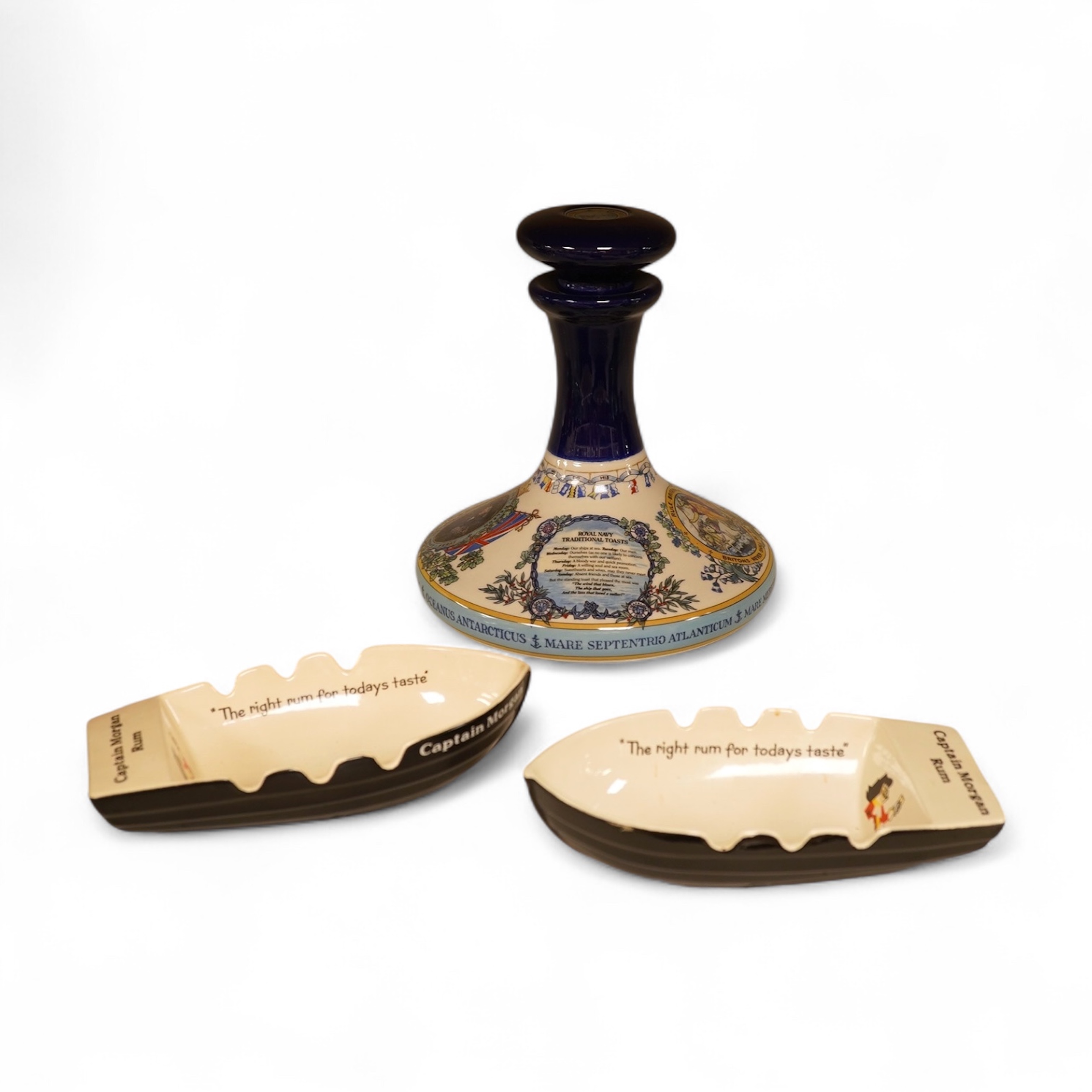 Wade 'Purser's Navy Rum Decanter' and two Captain Morgan rum boat ashtrays, decanter 24cm high